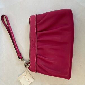 Magenta Coach Wristlet NWT.   Zip closure. 
Leather.  Roomy, versatile